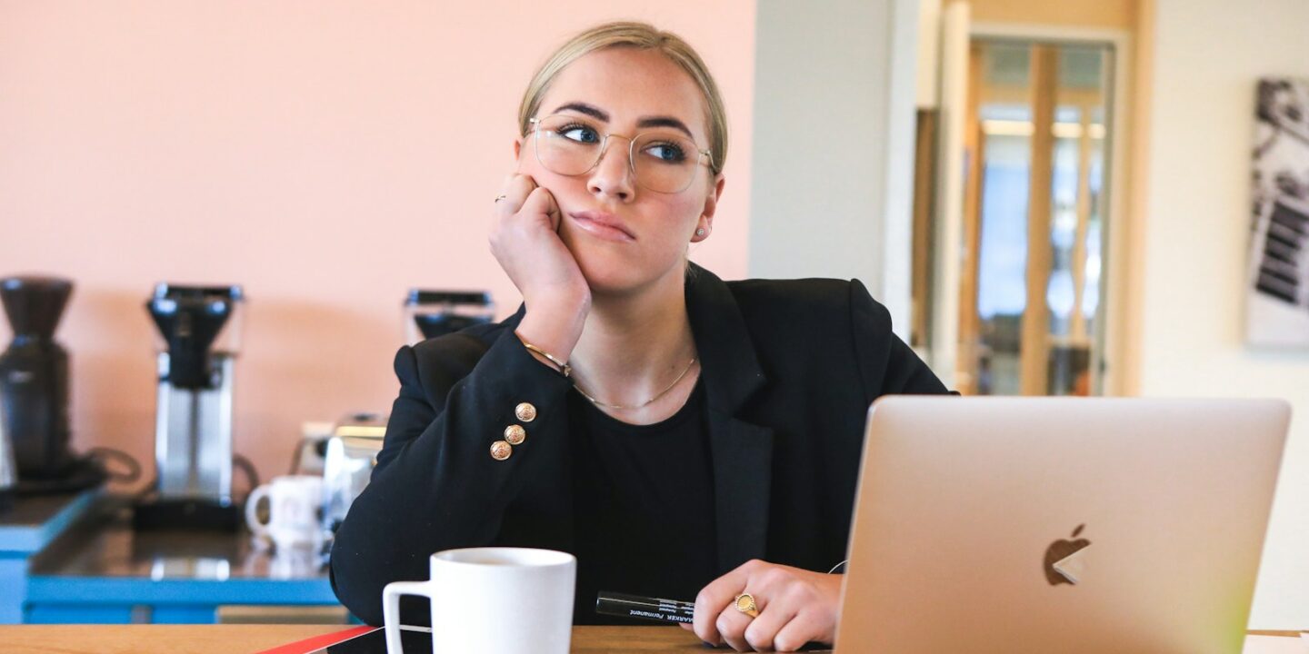 woman in black long sleeve shirt using macbook