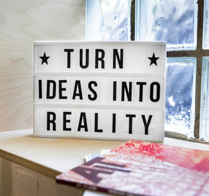 white and black wooden quote board