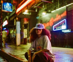 A person sitting on a skateboard on a city street